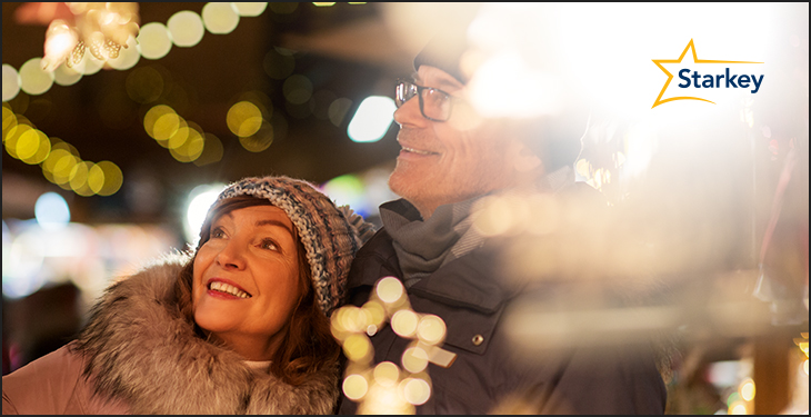 Image of senior couple out and about under holiday lights